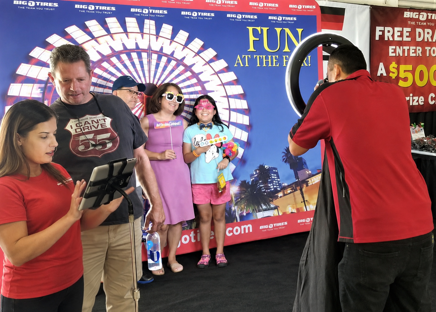 Attendees enjoying a branded photo booth at a corporate event